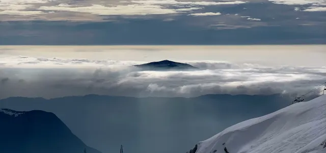 snow covered mountain under cloudy sky during daytime by Mihály Köles courtesy of Unsplash.